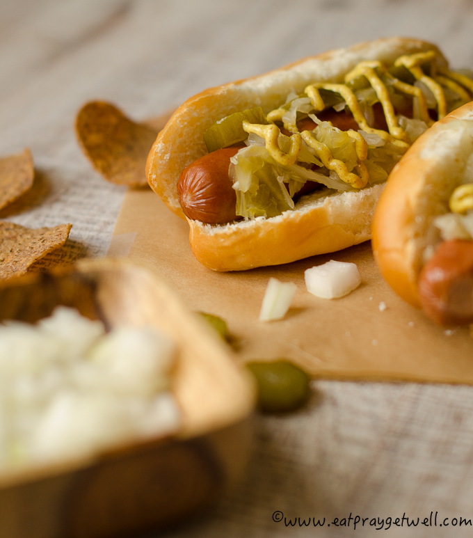 close up of hot dog with sauerkraut and mustard