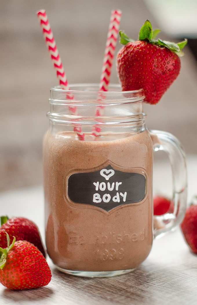 Close up of strawberry smoothie in a glass that says love your body