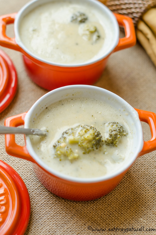 close up of broccoli cheese soup in orange bowl