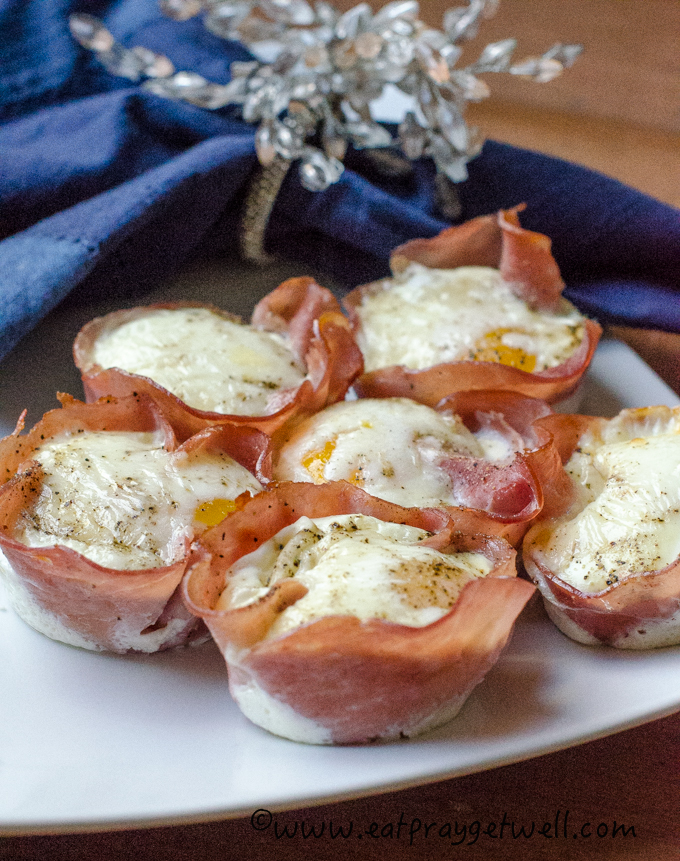 ham & egg cups on a white plate with blue napkin