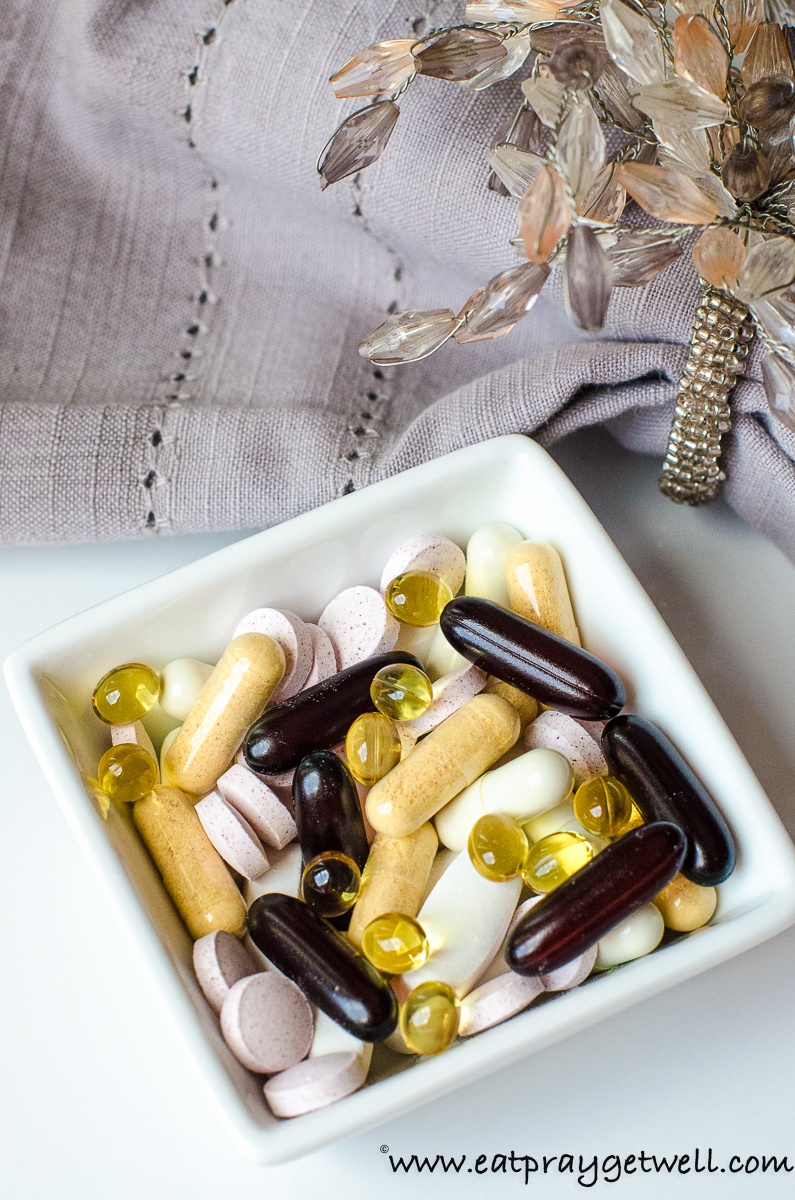 many different supplements in a square bowl