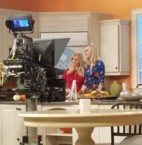two women on set of a of cooking television show