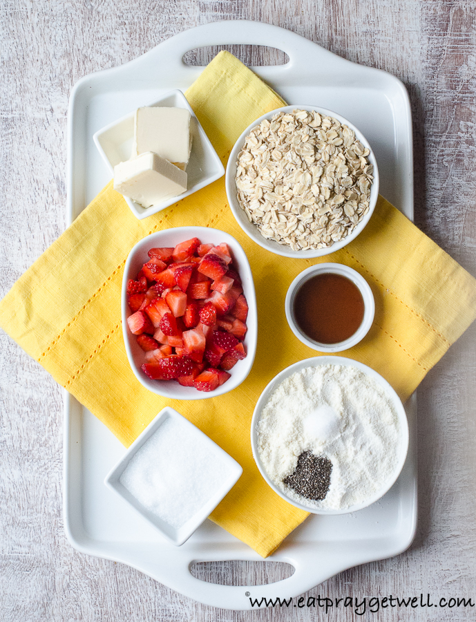 ingredients to make strawberry oatmeal bars on a white platter