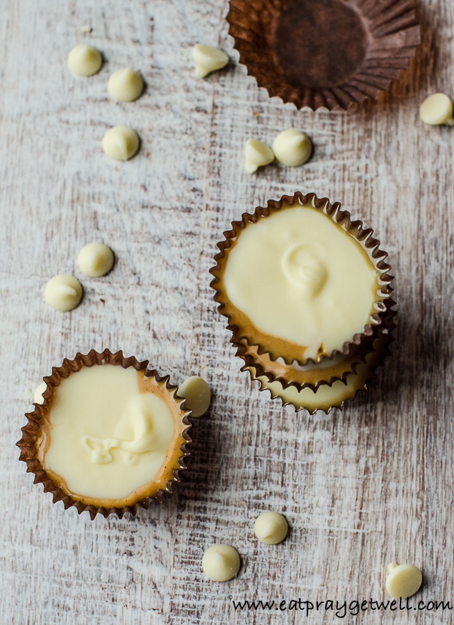close up of white chocolate reese's cups with white chocolate chips surrounding them
