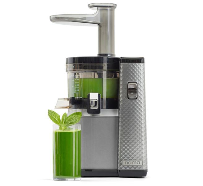 Nama Juicer with a glass of green juice